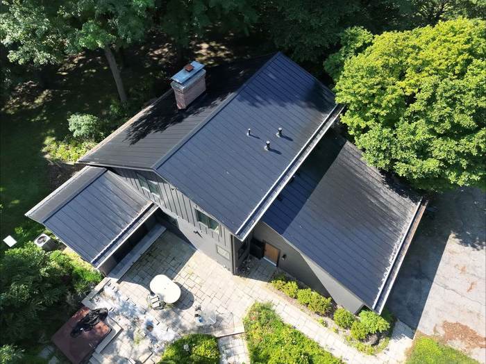 Completed black standing-seam metal roof