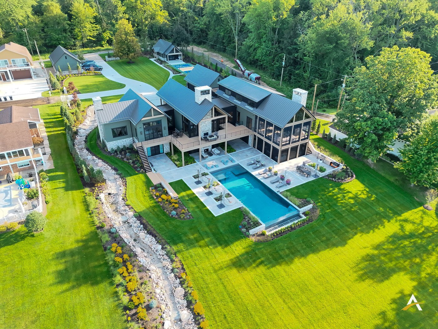 Aerial daylight view of the rear elevation and pool