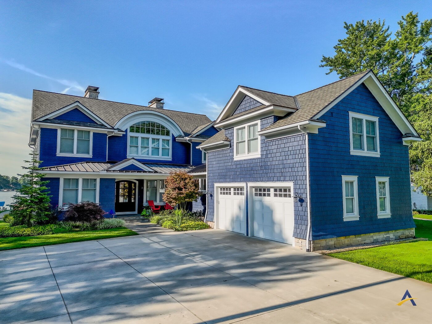 Front elevation of the home with driveway and garage in daylight
