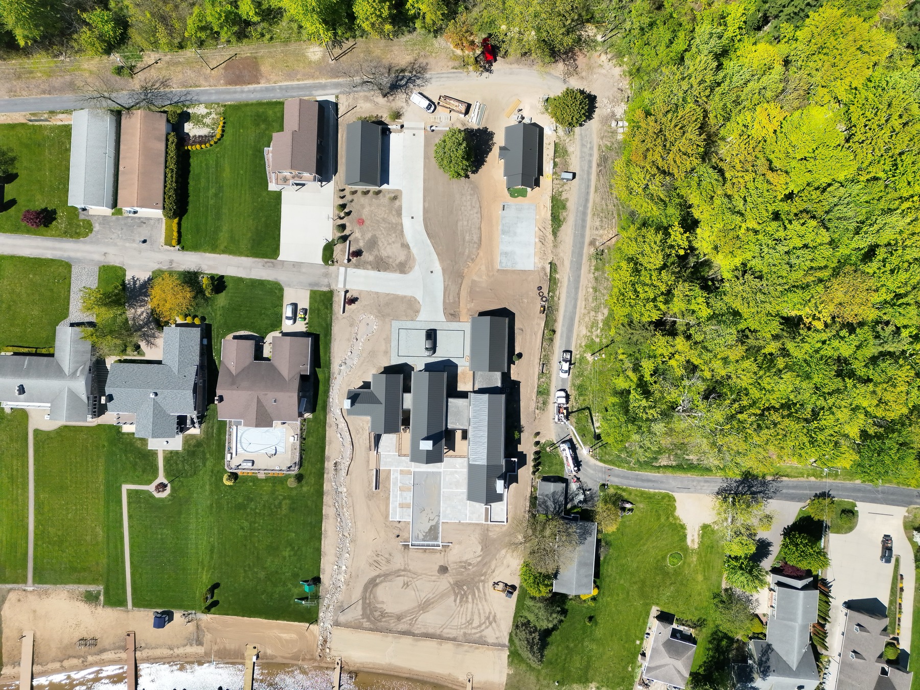 Straight-down aerial view of the completed home and surrounding property